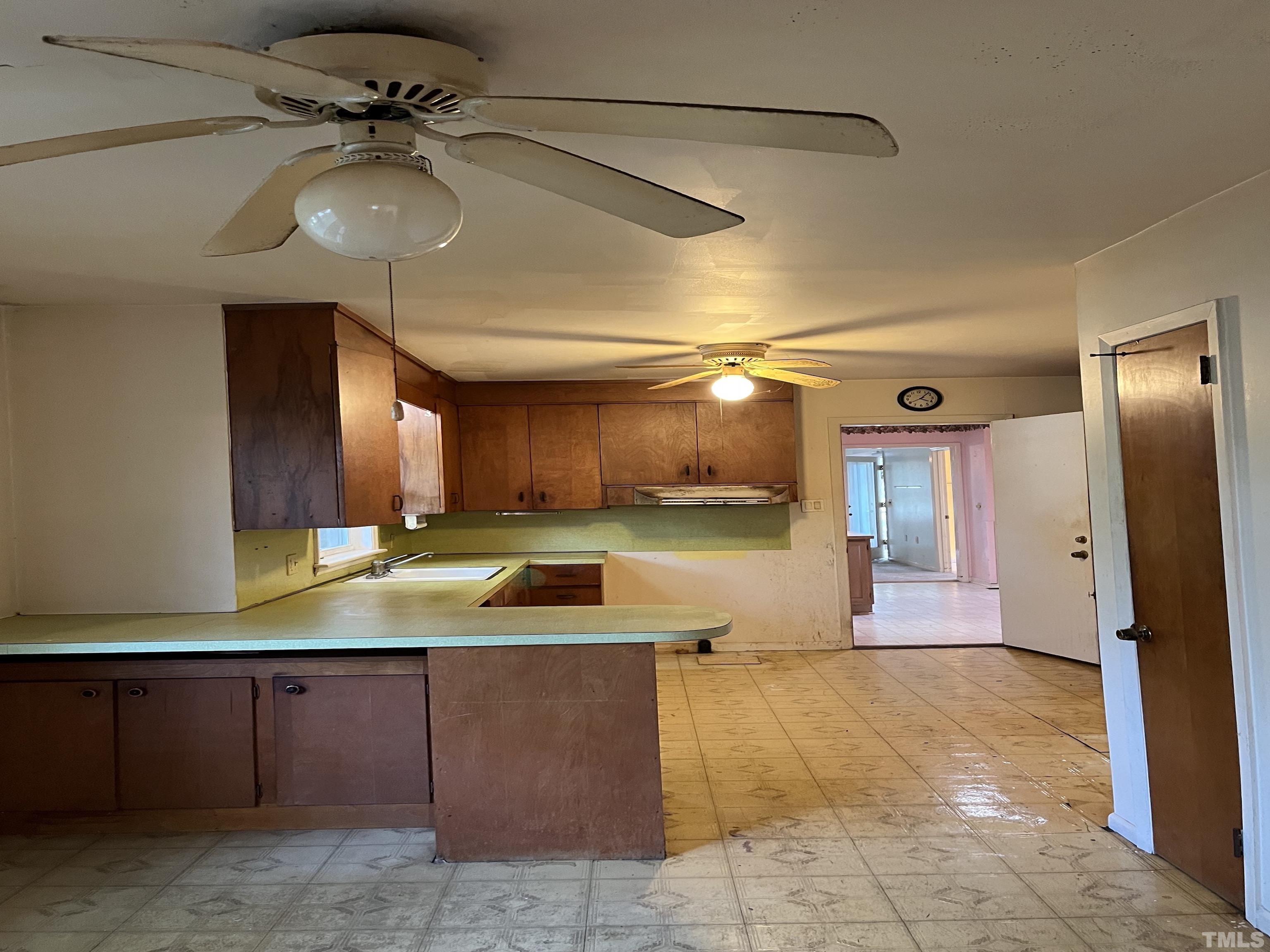 2171 Bud Lipscomb Road Willow Spring, NC 27592 - Photo 12 of 20 a view of a kitchen with a sink and a refrigerator