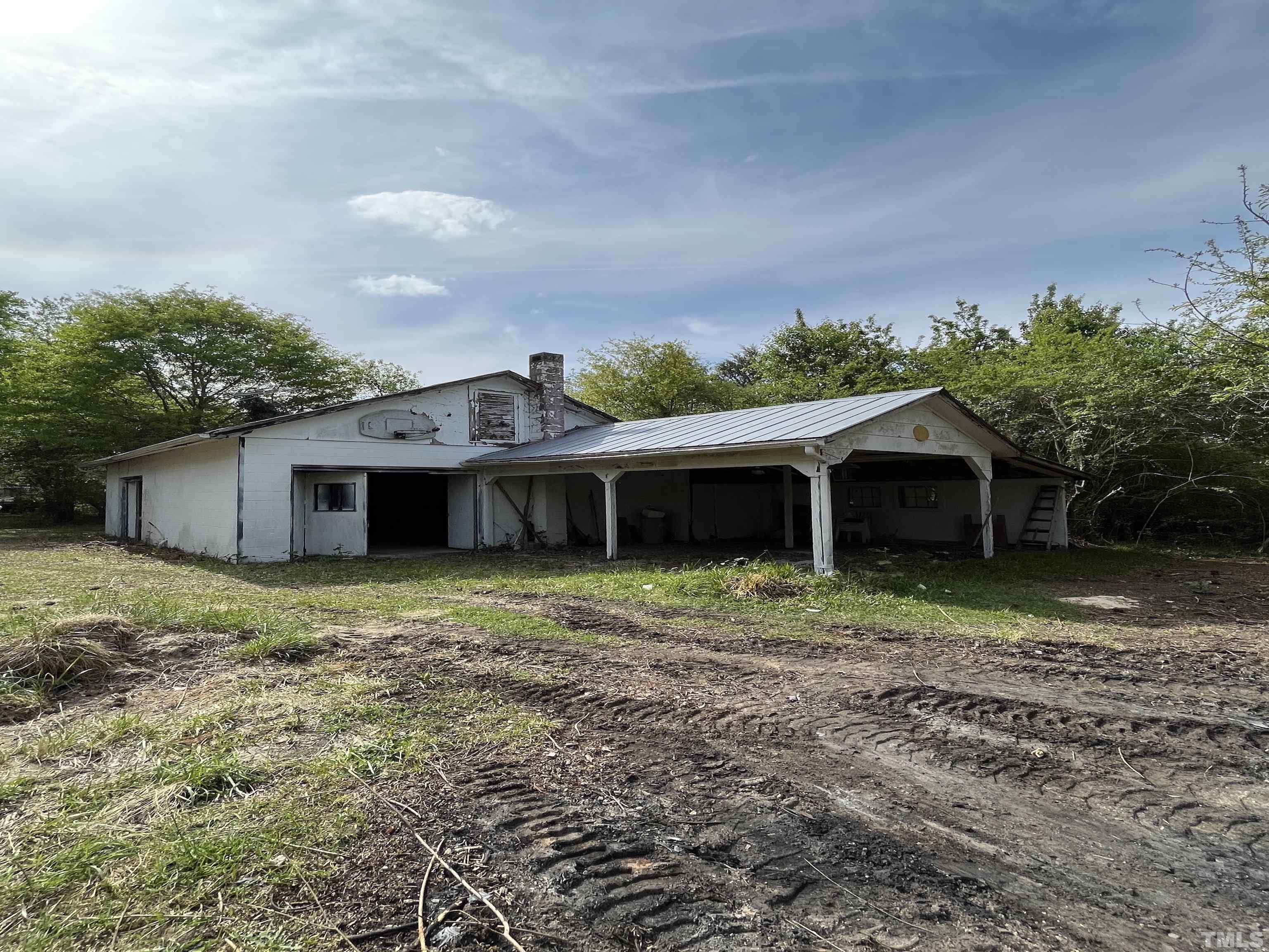 2171 Bud Lipscomb Road Willow Spring, NC 27592 - Photo 17 of 20 a house is sitting in middle of the green field
