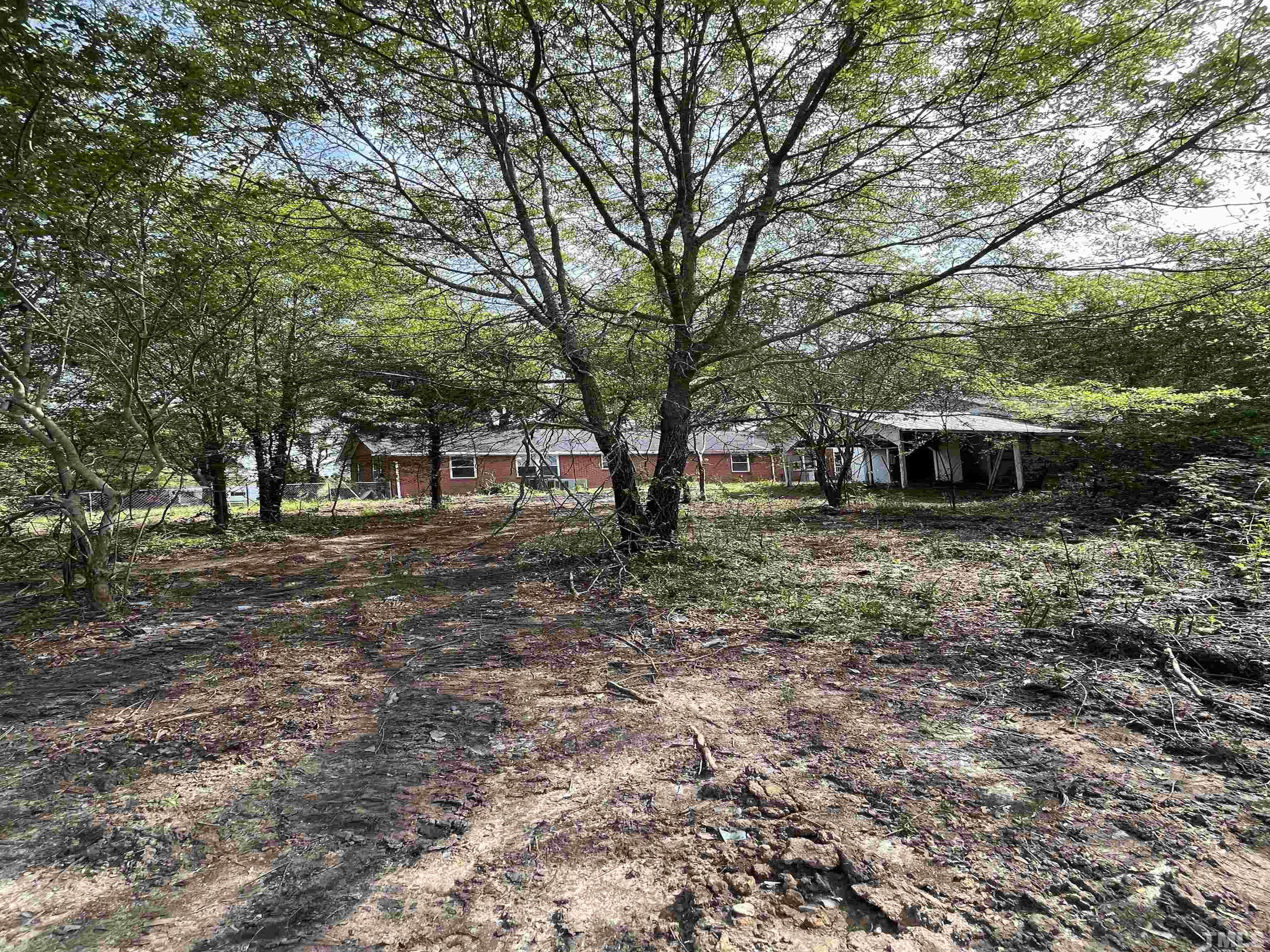 2171 Bud Lipscomb Road Willow Spring, NC 27592 - Photo 6 of 20 a backyard of a house with lots of green space
