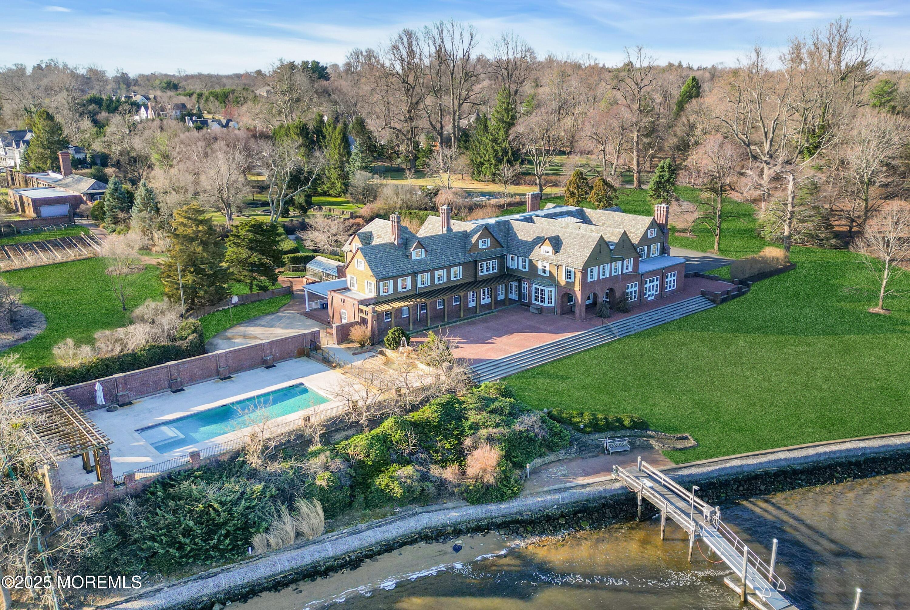 66 A West River Road Rumson, NJ 07760 - Photo 1 of 34 an aerial view of a house with garden space ocean view and mountain view in back