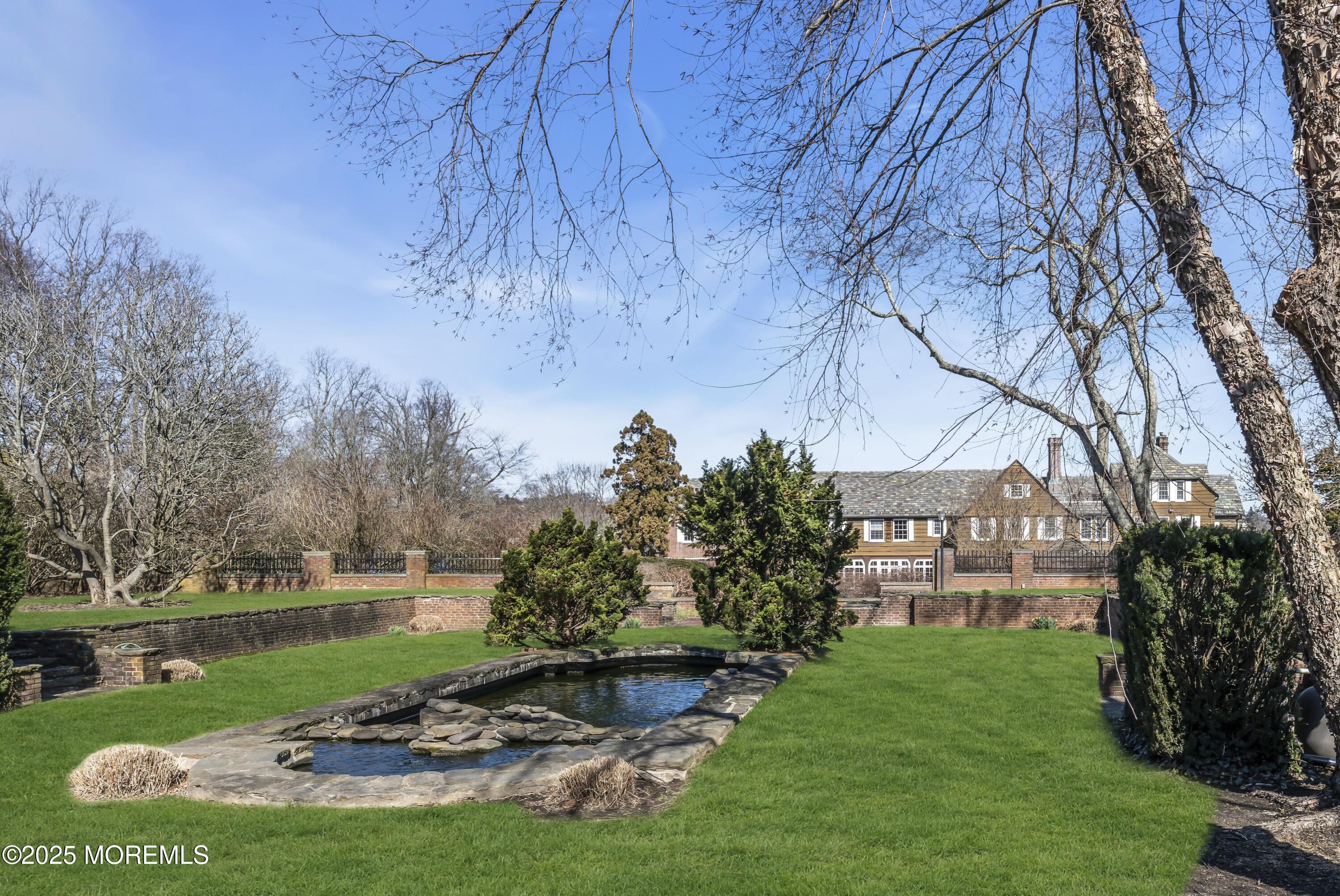 66 A West River Road Rumson, NJ 07760 - Photo 17 of 34 a view of a lake with a house in the background
