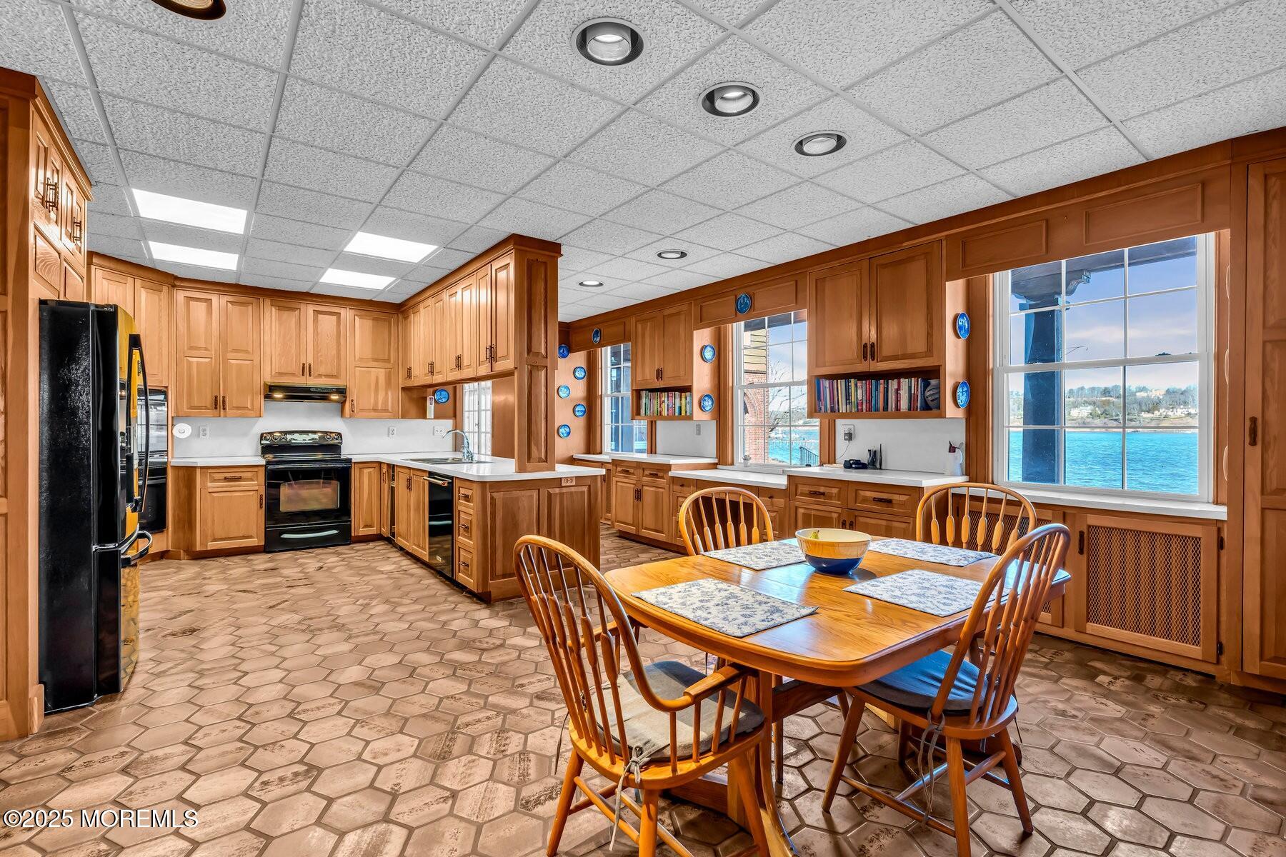 66 A West River Road Rumson, NJ 07760 - Photo 18 of 34 a view of a dining room with furniture a chandelier and kitchen view