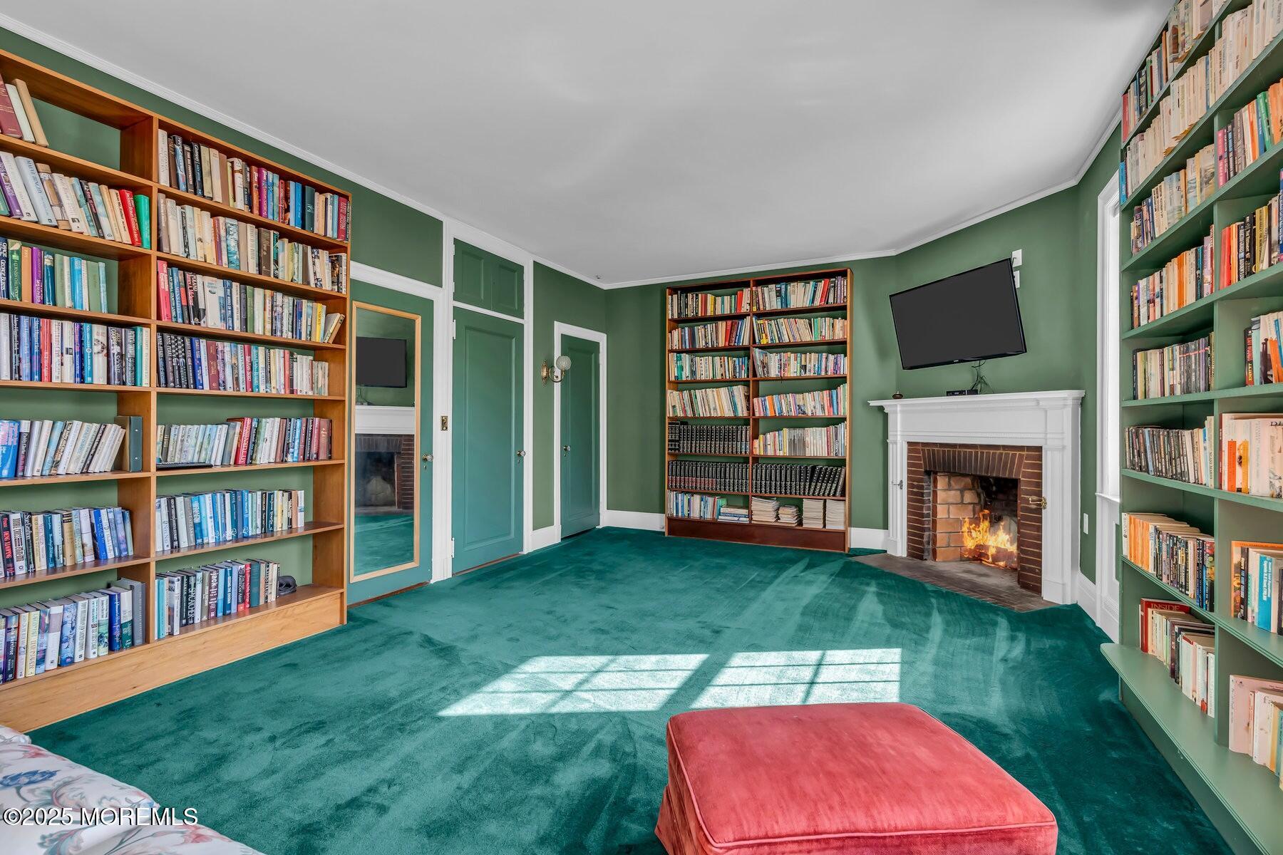 66 A West River Road Rumson, NJ 07760 - Photo 25 of 34 a living room with bookshelf and a fireplace