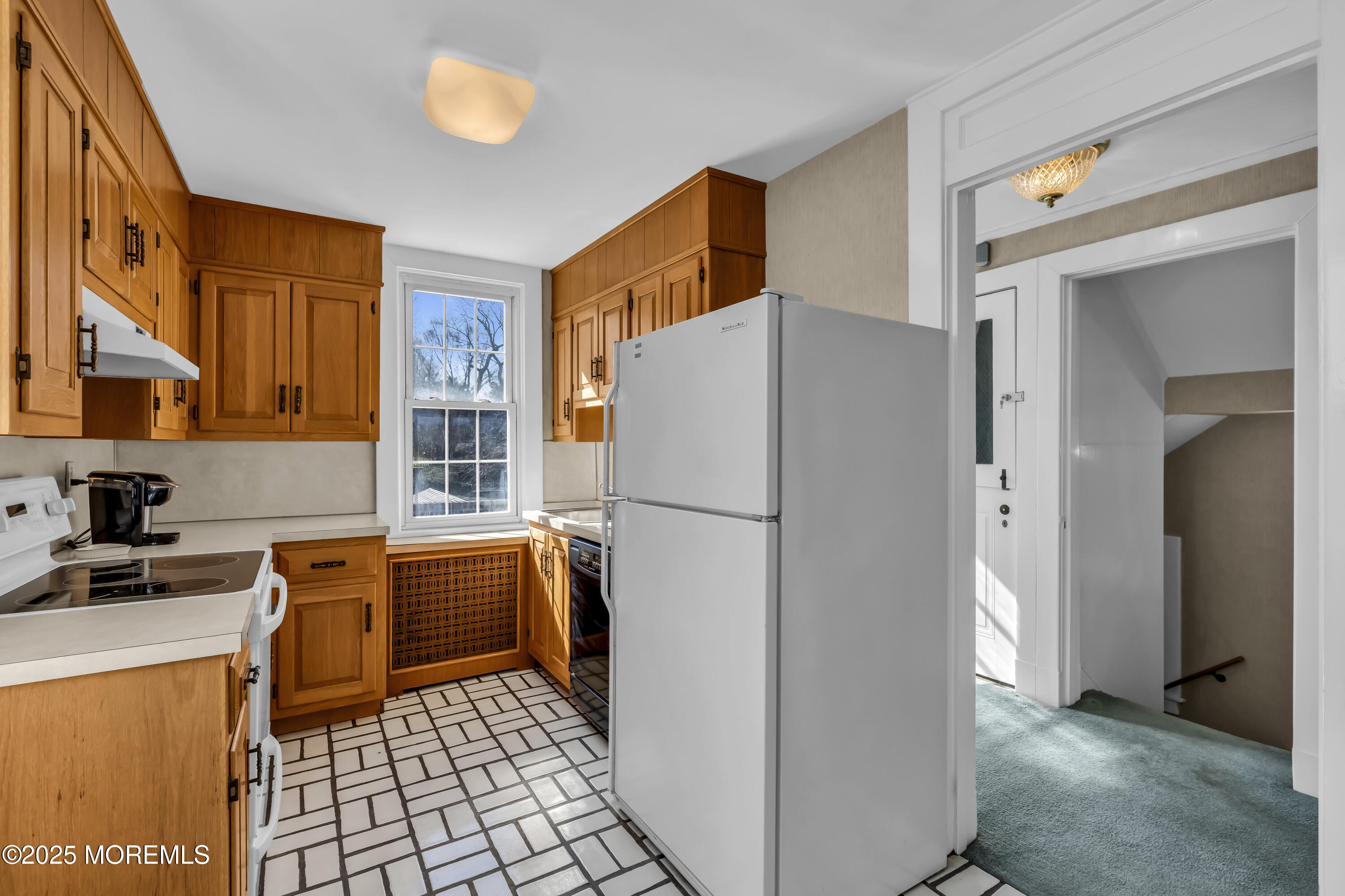 66 A West River Road Rumson, NJ 07760 - Photo 29 of 34 a white refrigerator freezer sitting inside of a kitchen