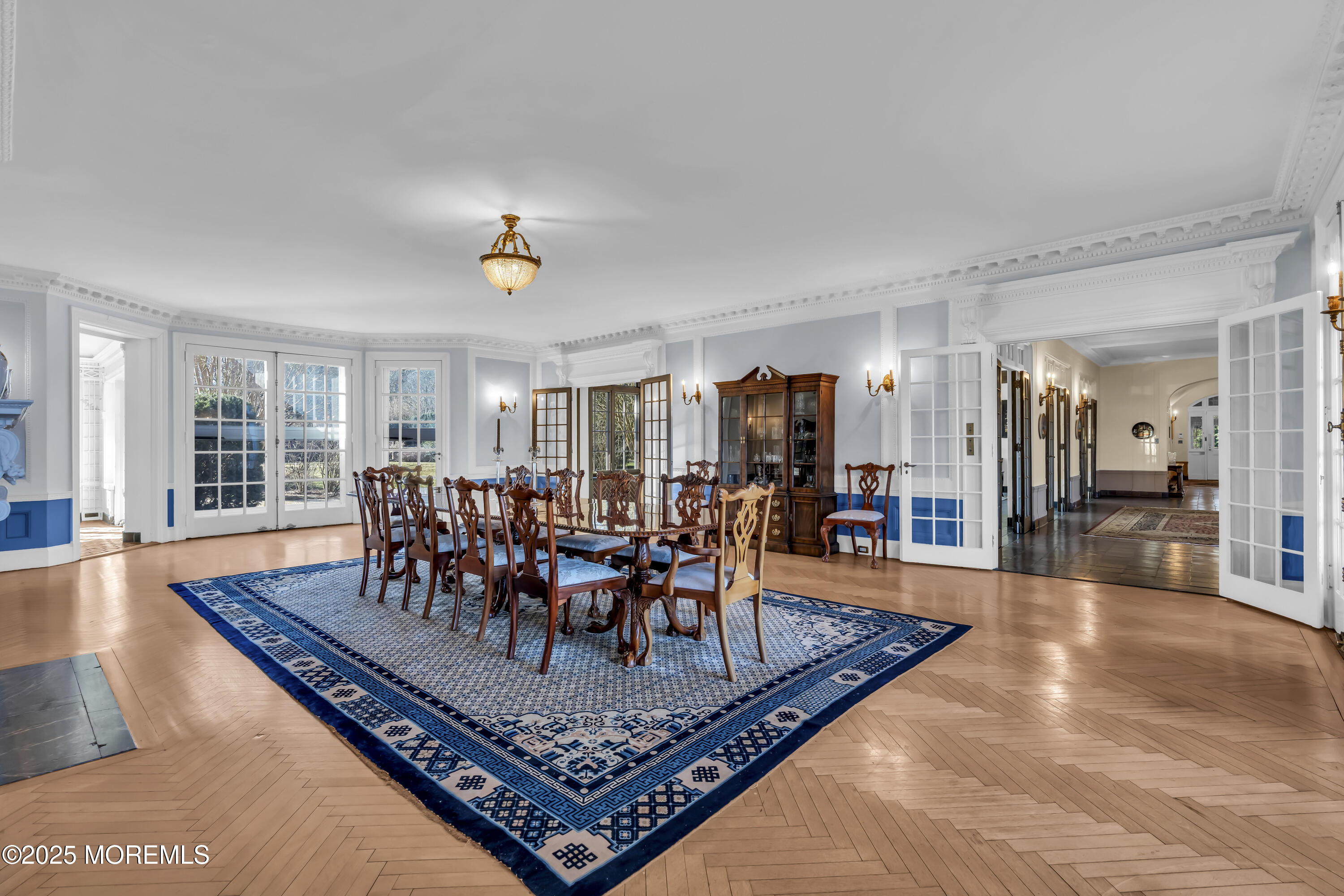 66 A West River Road Rumson, NJ 07760 - Photo 6 of 34 a dining room with wooden floor a rug and a chandelier
