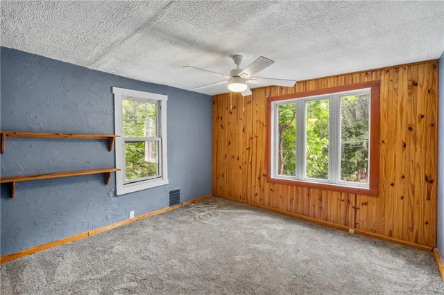 a view of a hallway with furniture and a window