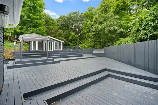 a side view of a house with a wooden deck