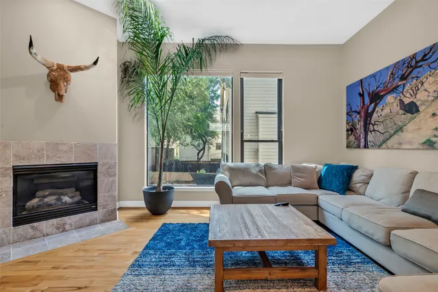 a living room with furniture a rug and a fireplace