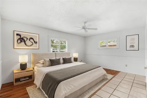 a view of a room with wooden floor and a ceiling fan
