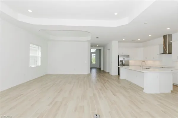 a view of a kitchen with white cabinets