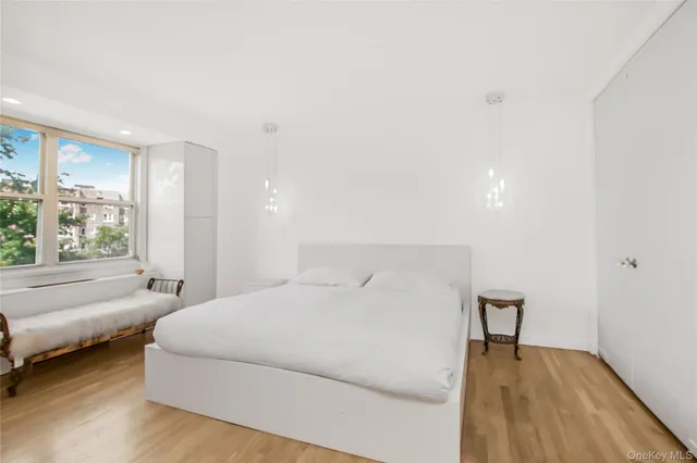 a bedroom with a bed and a large window