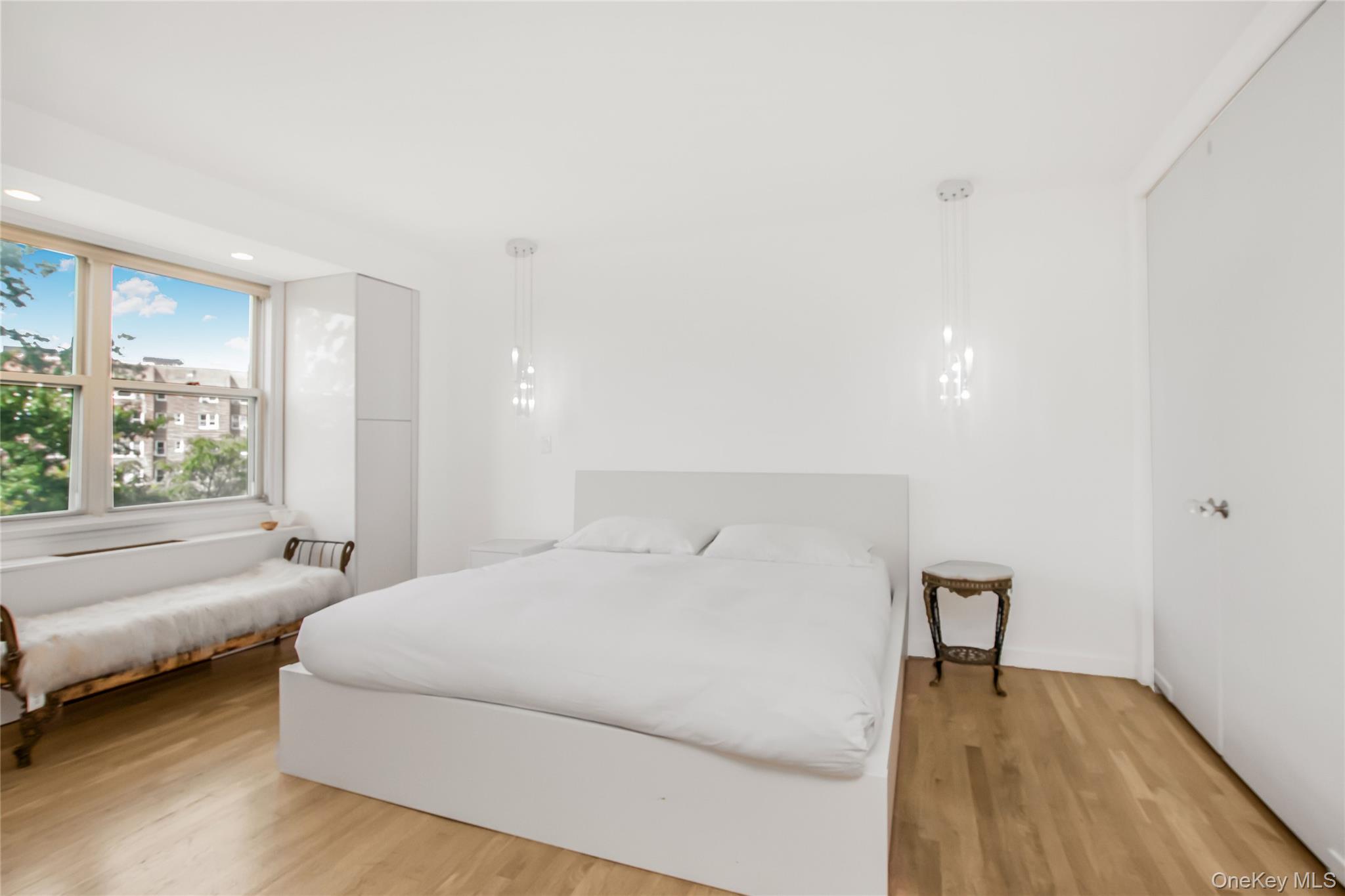 3777 Independence Avenue, Unit 7H Bronx, NY 10463 - Photo 12 of 26 a bedroom with a bed and a large window