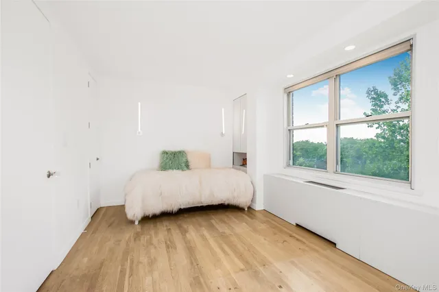 a spacious bedroom with a bed and a large window