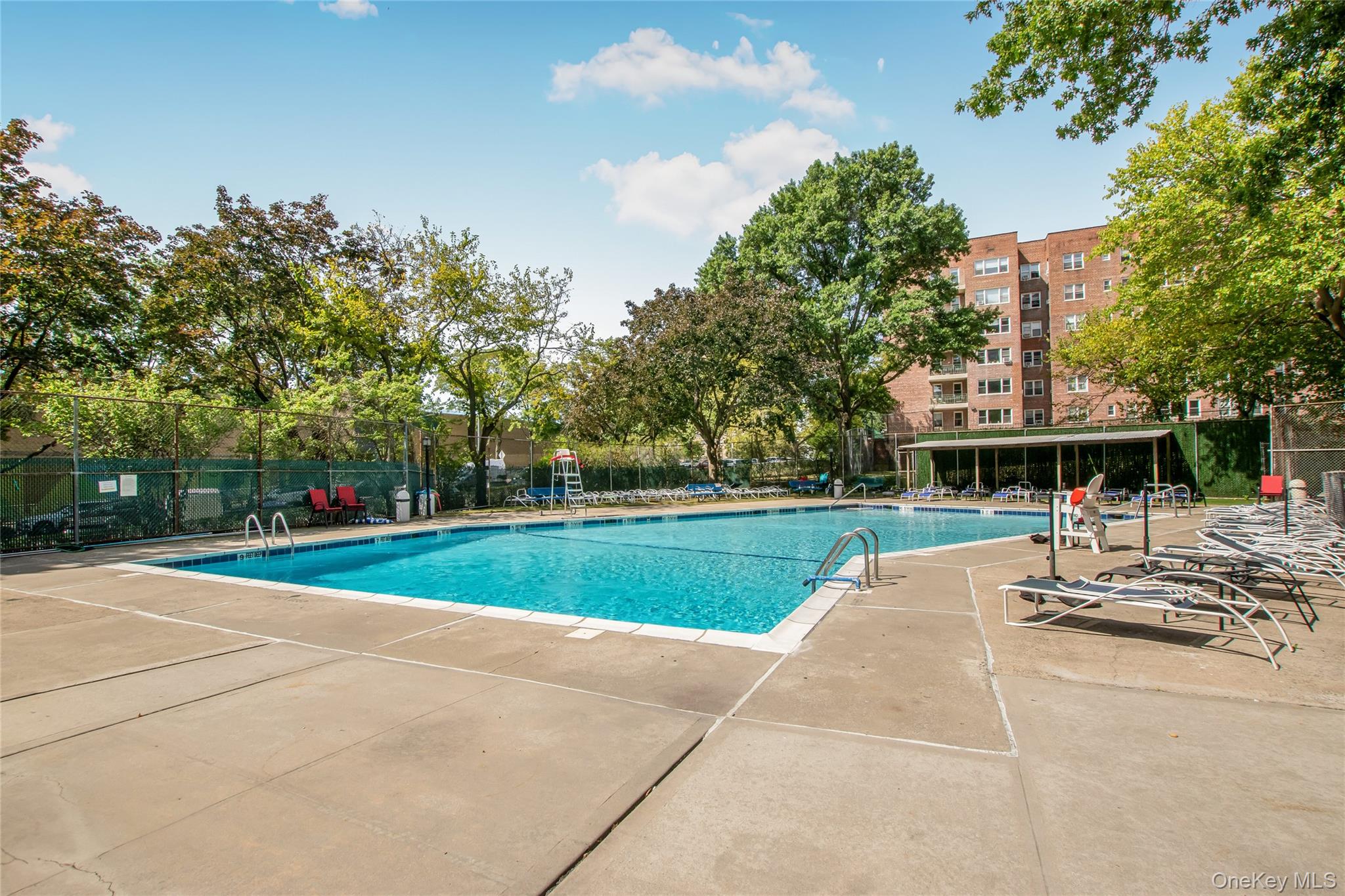 3777 Independence Avenue, Unit 7H Bronx, NY 10463 - Photo 22 of 26 a view of a swimming pool and trees in the background