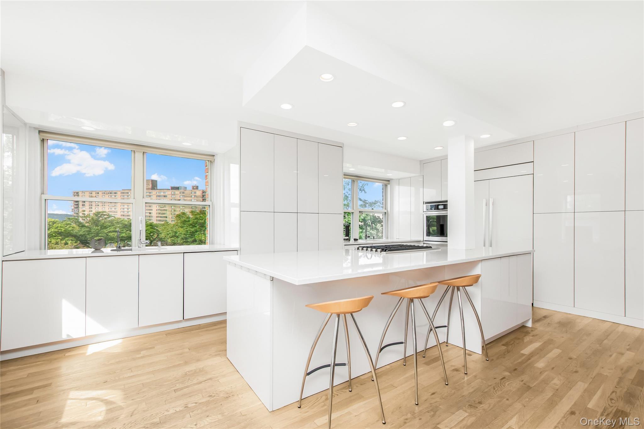 3777 Independence Avenue, Unit 7H Bronx, NY 10463 - Photo 3 of 26 a kitchen with stainless steel appliances kitchen island granite countertop a refrigerator a stove a sink and white cabinets with wooden floor