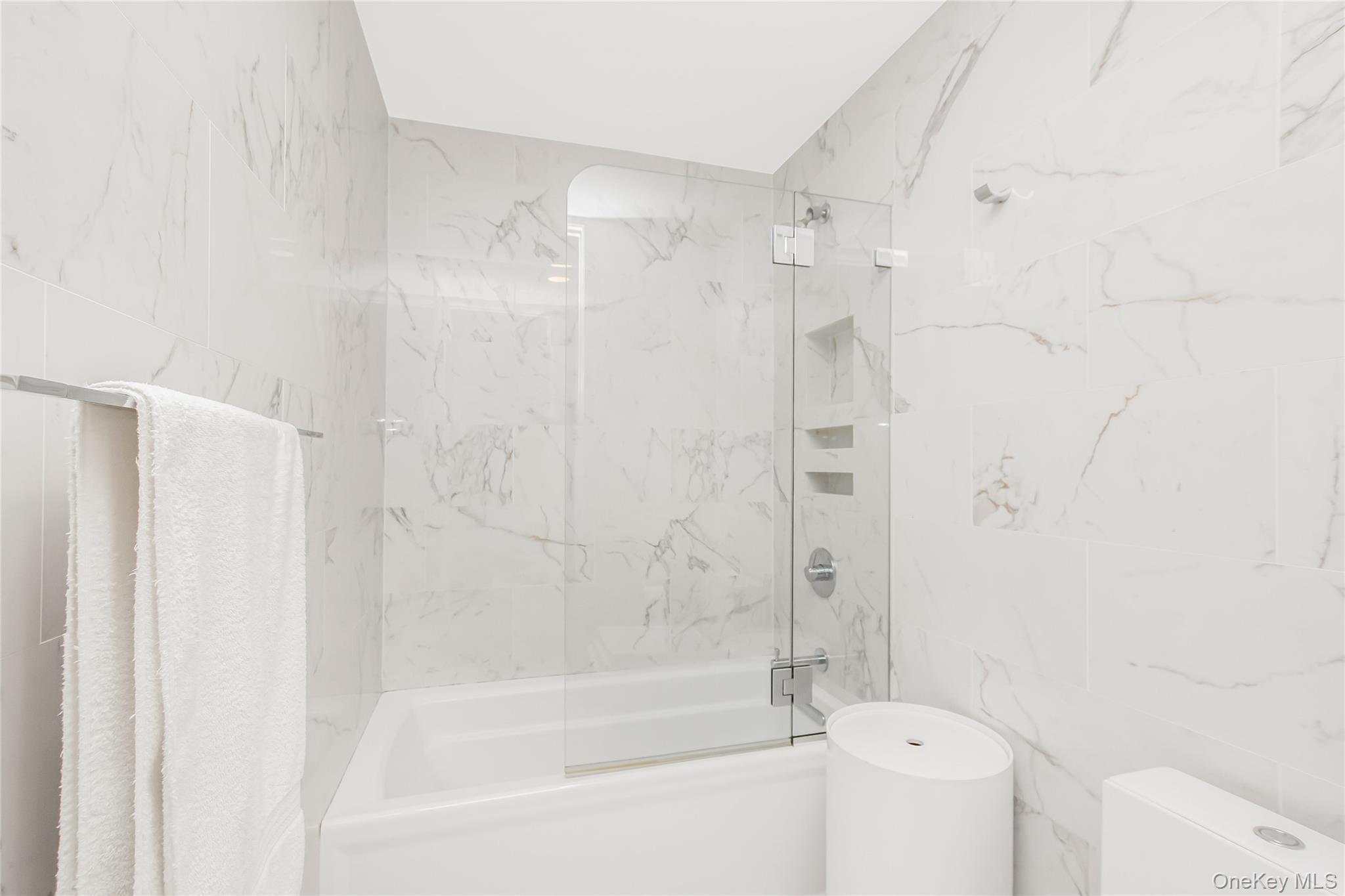 3777 Independence Avenue, Unit 7H Bronx, NY 10463 - Photo 10 of 26 a bathroom with a bathtub shower sink and toilet