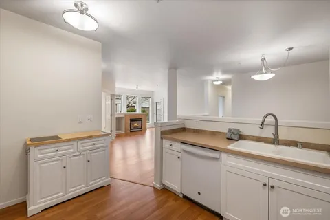 a spacious bathroom with a double vanity sink a mirror and a bathtub