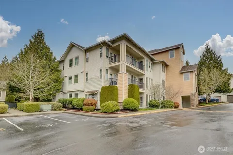 a view of a white house with a yard and road