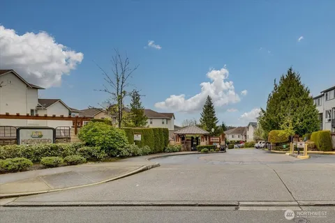 a living room with lots of furniture and kitchen view