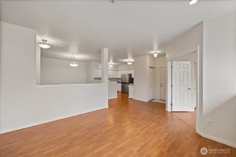 a kitchen with granite countertop white cabinets and white appliances
