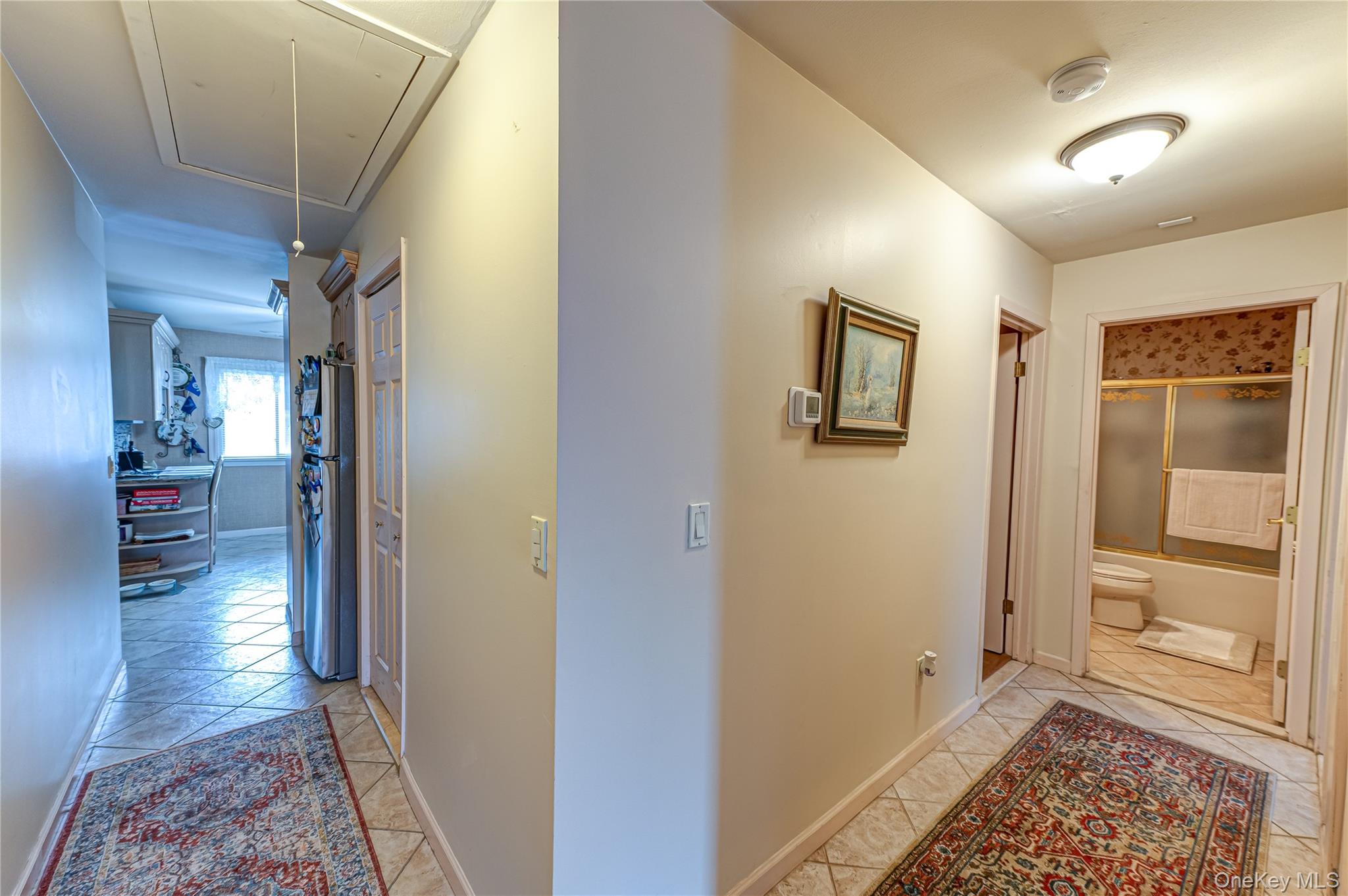 12 Blue Point Road East, Unit 12 Holtsville, NY 11742 - Photo 14 of 20 a view of hallway with mirror and a window