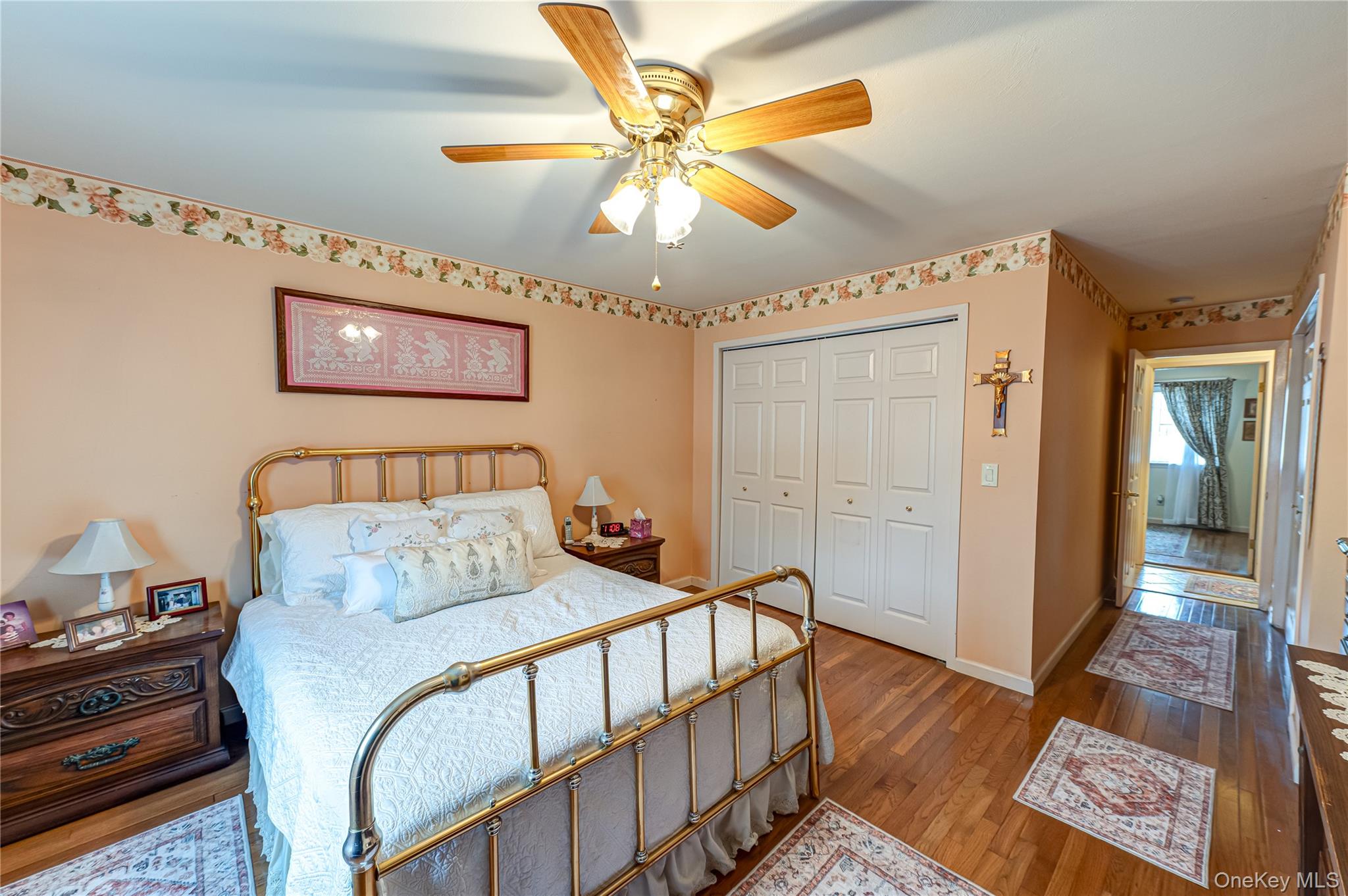 12 Blue Point Road East, Unit 12 Holtsville, NY 11742 - Photo 15 of 20 a bedroom with a bed and wooden floor