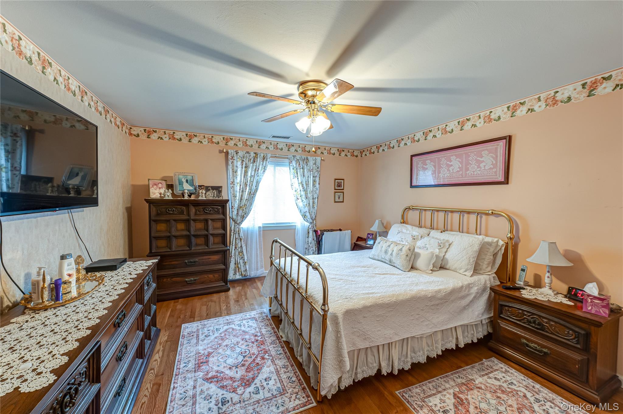 12 Blue Point Road East, Unit 12 Holtsville, NY 11742 - Photo 16 of 20 a bedroom with bed and a chandelier