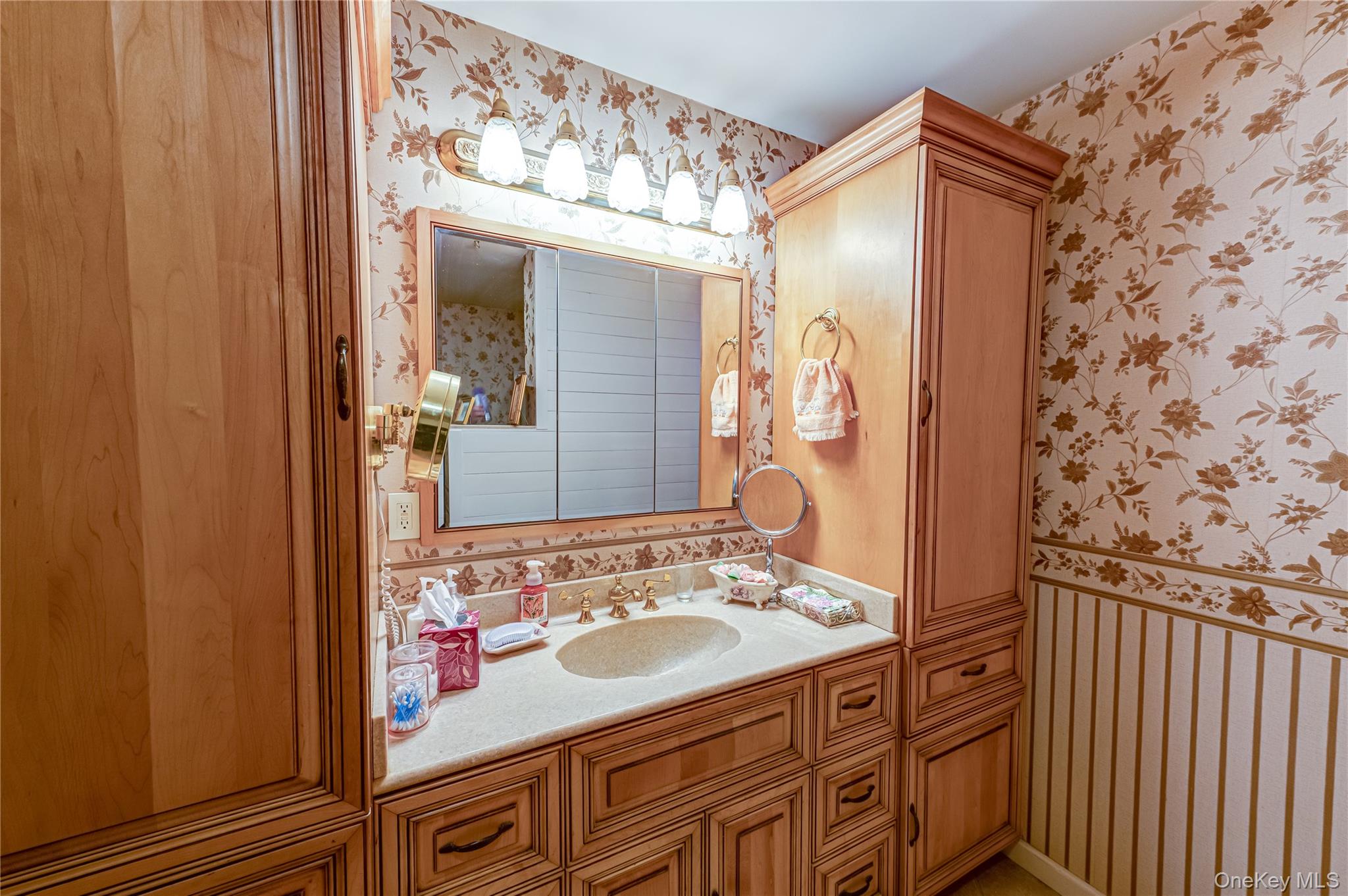 12 Blue Point Road East, Unit 12 Holtsville, NY 11742 - Photo 17 of 20 a bathroom with a sink and a mirror