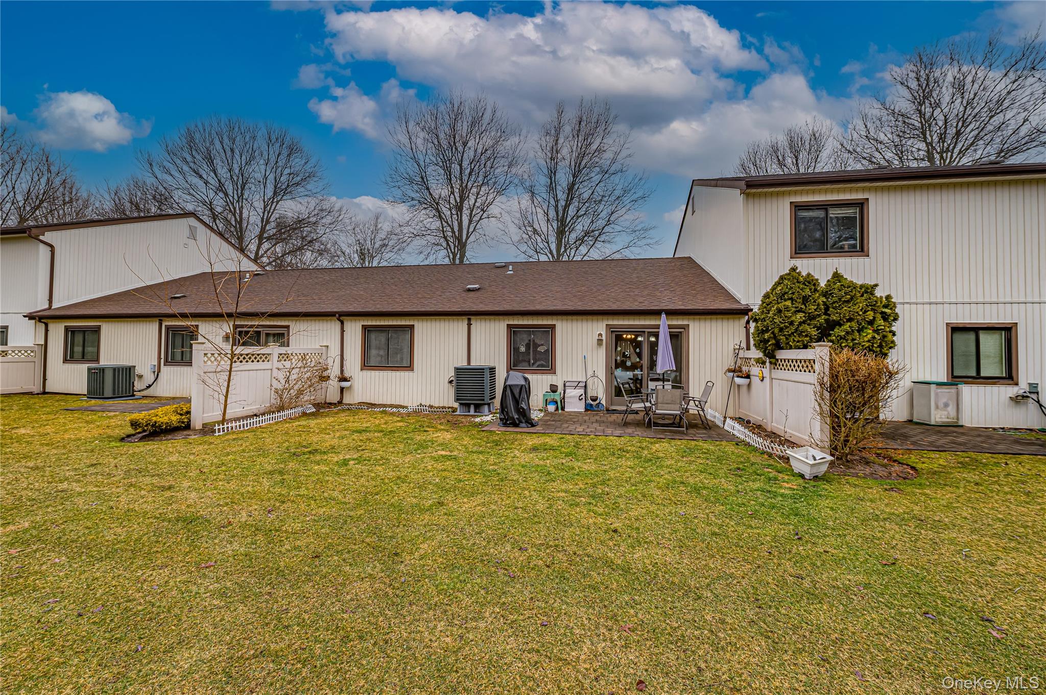 12 Blue Point Road East, Unit 12 Holtsville, NY 11742 - Photo 4 of 20 a front view of a house with yard porch and furniture