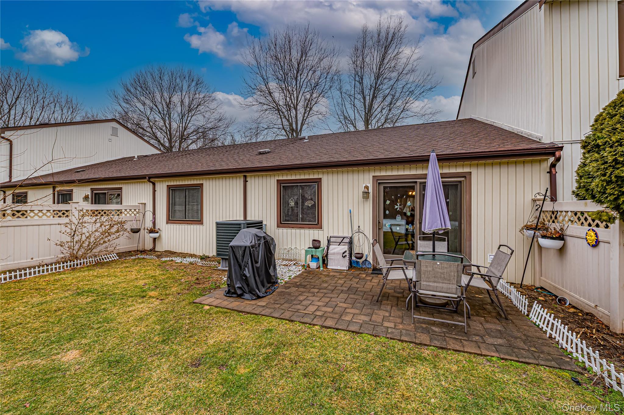 12 Blue Point Road East, Unit 12 Holtsville, NY 11742 - Photo 5 of 20 a house view with a seating space and garden space