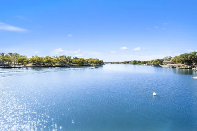 a view of a lake with houses in the background