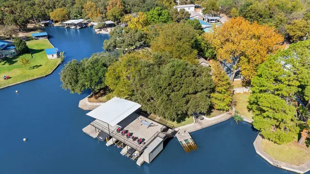 an aerial view of a house with a yard basket ball court and outdoor seating