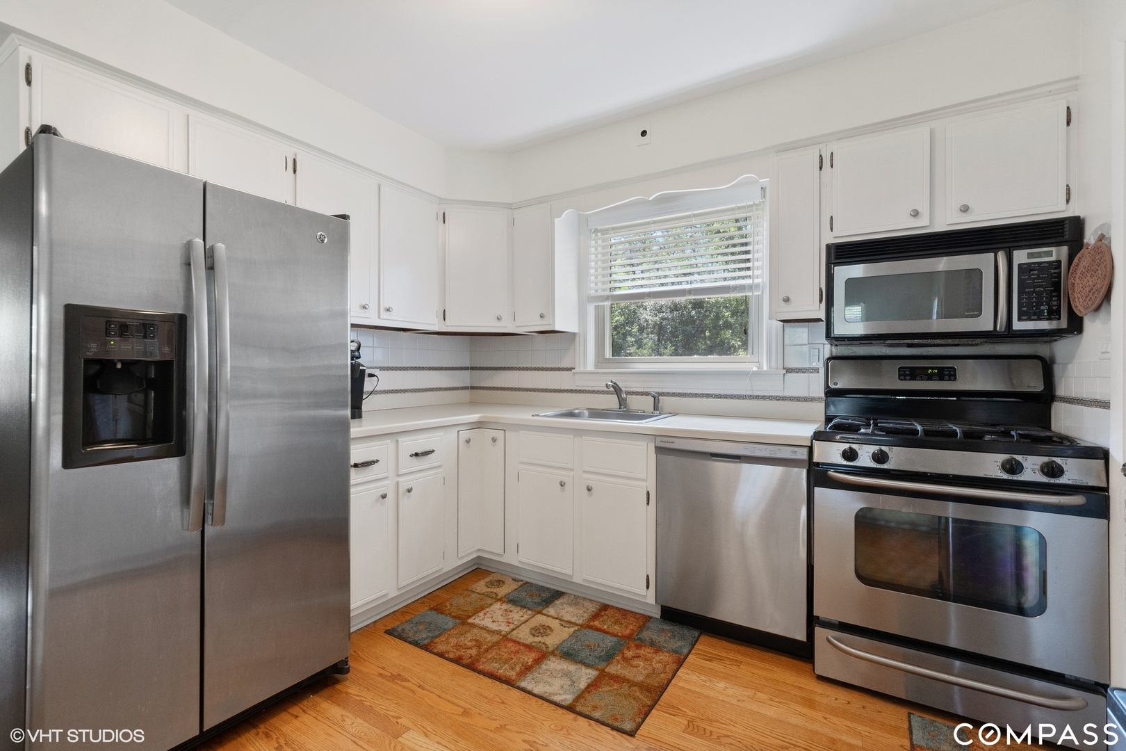 706 Deerpath Drive Deerfield, IL 60015 - Photo 3 of 11 a kitchen with cabinets stainless steel appliances and window