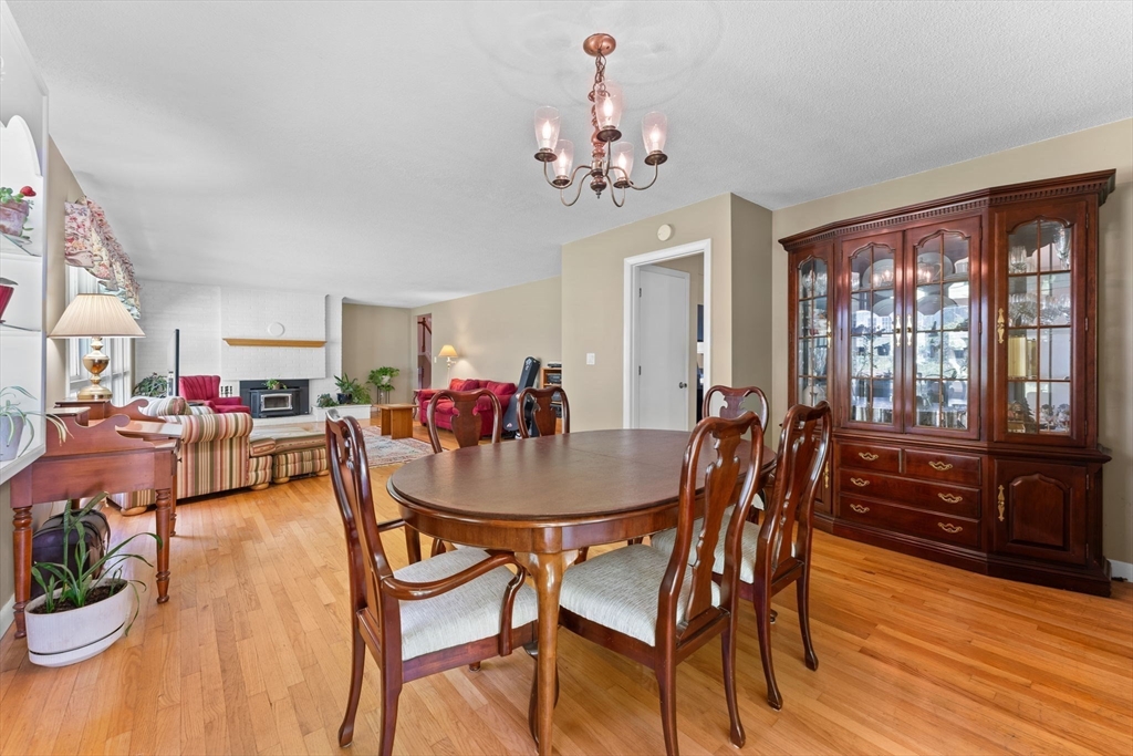 46 Highland Road Boxford, MA 01921 - Photo 11 of 41 a dining room with furniture a chandelier and wooden floor