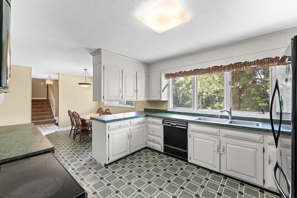 46 Highland Road Boxford, MA 01921 - Photo 13 of 41 a kitchen with a sink stove and cabinets