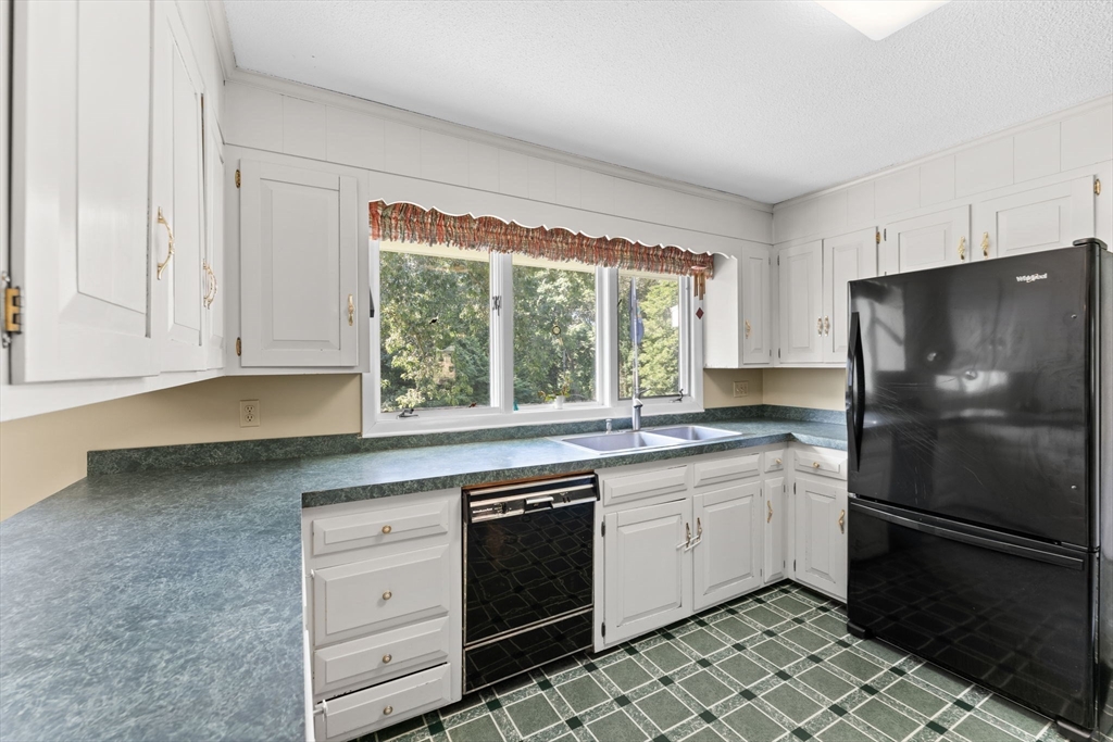 46 Highland Road Boxford, MA 01921 - Photo 15 of 41 a kitchen with a stove a sink and a refrigerator