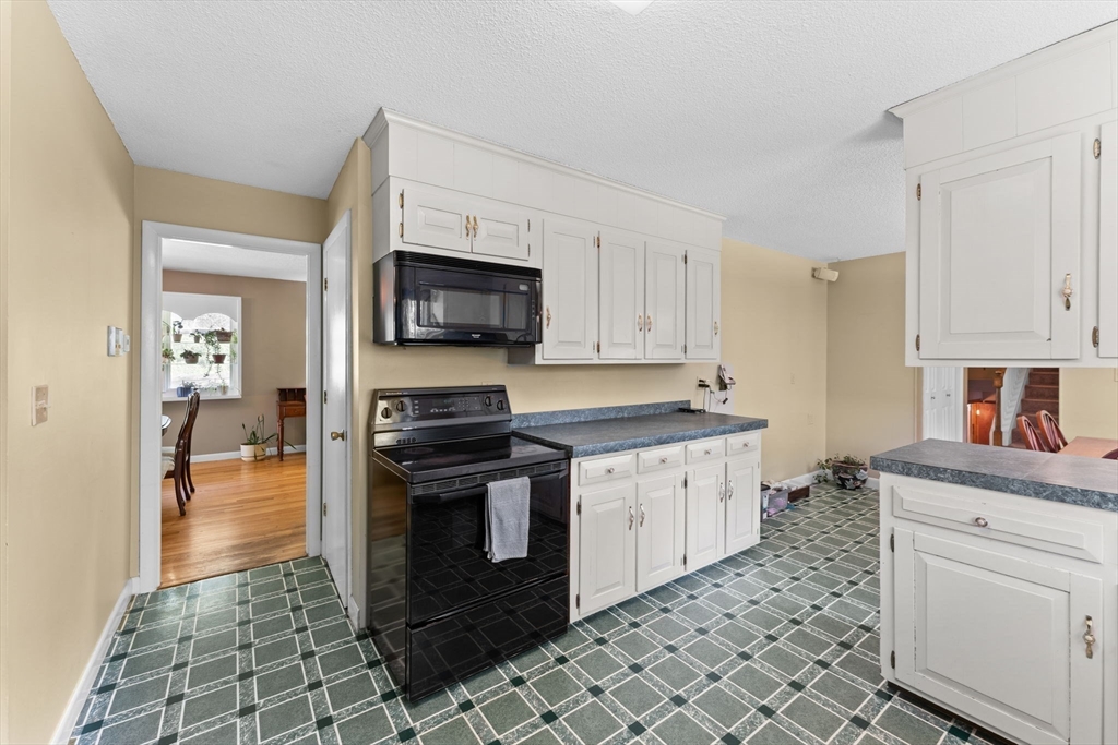 46 Highland Road Boxford, MA 01921 - Photo 16 of 41 a kitchen with stainless steel appliances granite countertop a stove a sink and a microwave