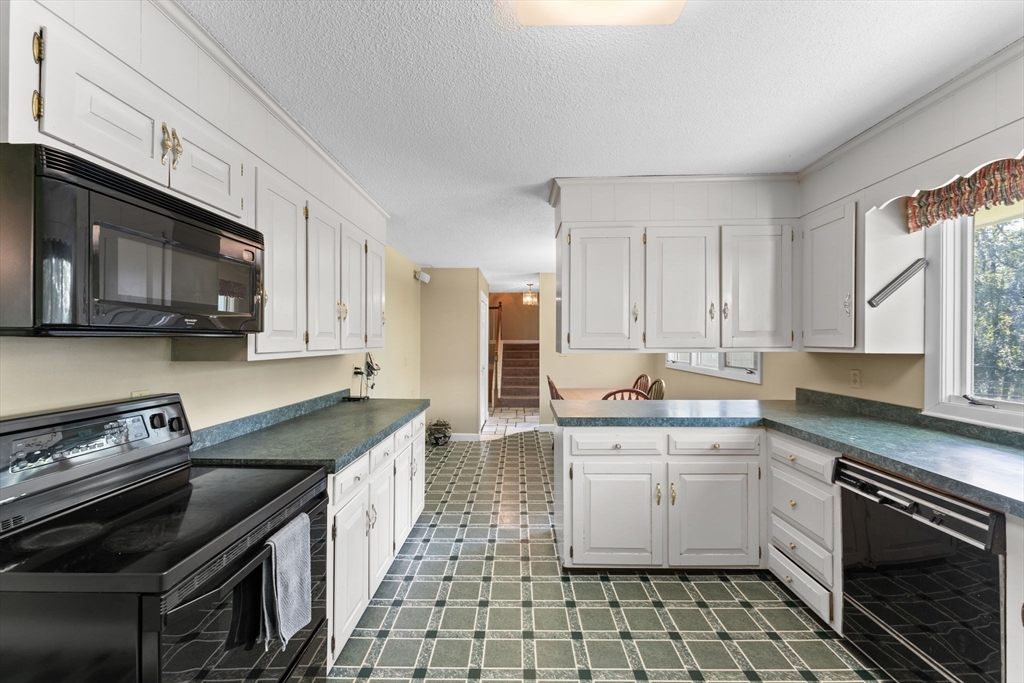 46 Highland Road Boxford, MA 01921 - Photo 17 of 41 a kitchen with a sink stove and microwave