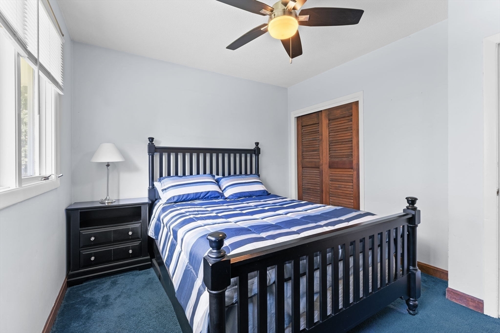 46 Highland Road Boxford, MA 01921 - Photo 23 of 41 a bedroom with a bed and a chandelier