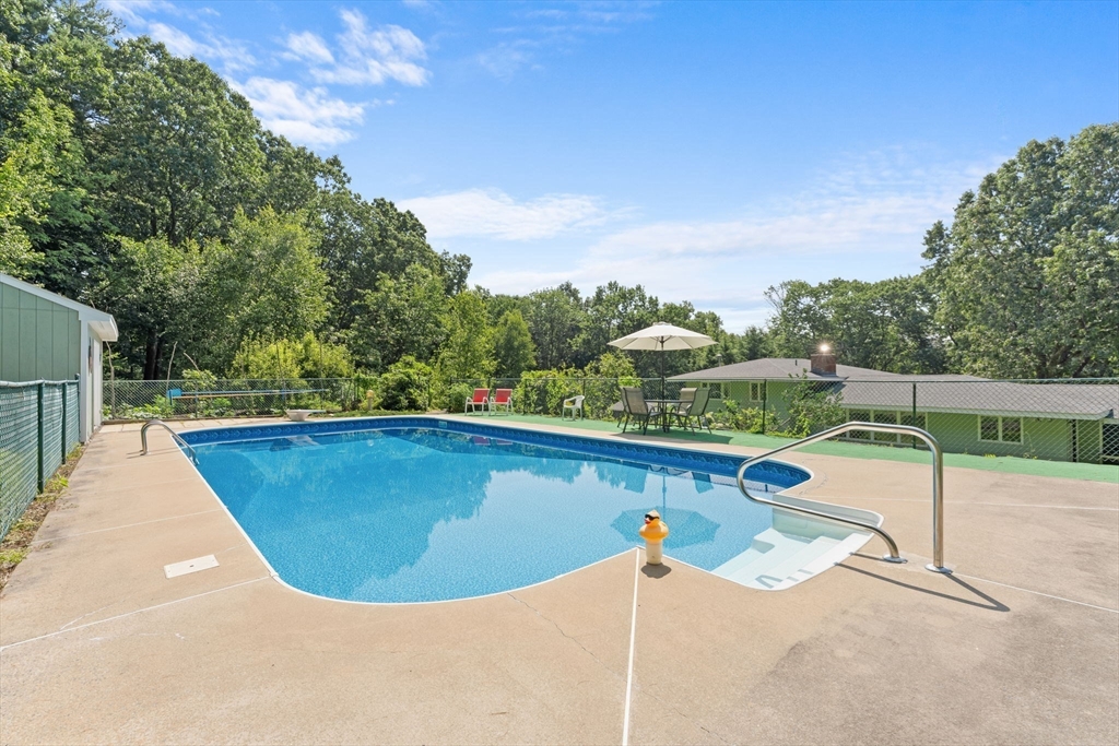 46 Highland Road Boxford, MA 01921 - Photo 39 of 41 a view of a swimming pool with a lounge chair