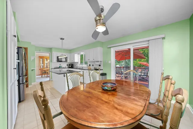 a dining room with furniture a kitchen view and a chandelier