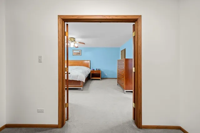 a bedroom with a bed and a mirror