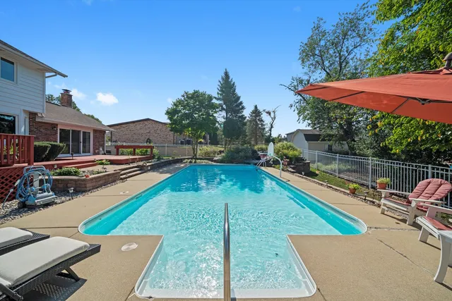an outdoor space with pool and furniture