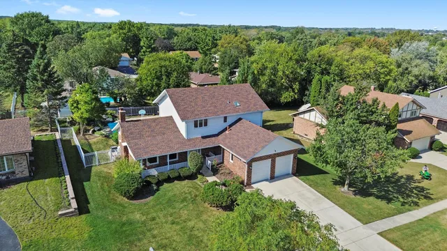 an aerial view of a house with a yard