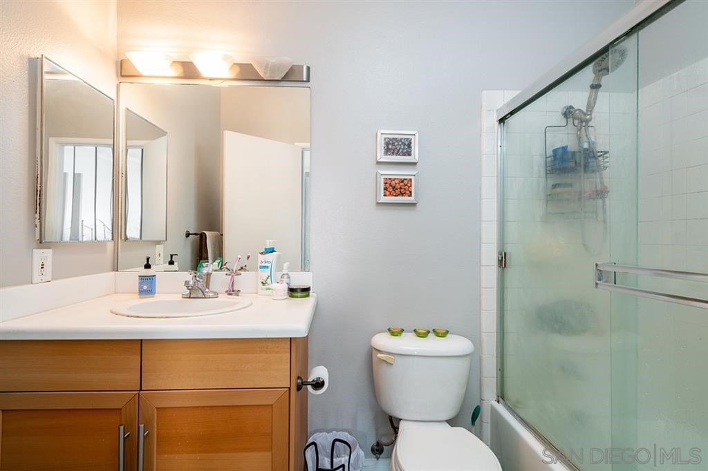 2650 Broadway, Unit 314 San Diego, CA 92102 - Photo 14 of 16 a bathroom with a sink mirror toilet and shower