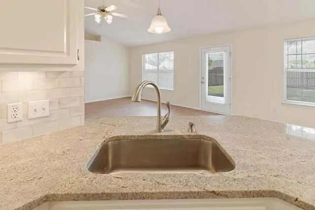 a kitchen with a sink cabinets and window