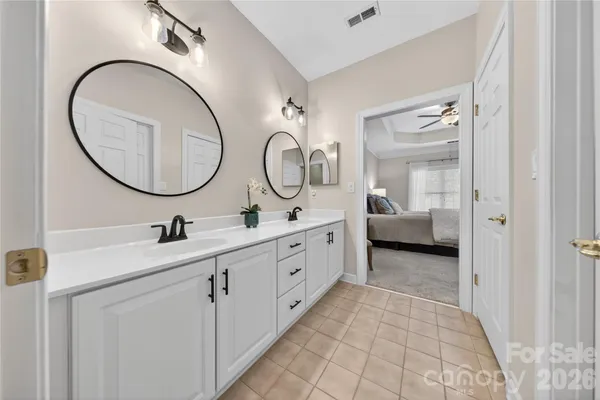 a spacious bathroom with a double vanity sink and a mirror