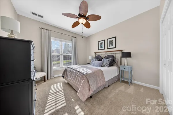 a bedroom with a bed and a ceiling fan