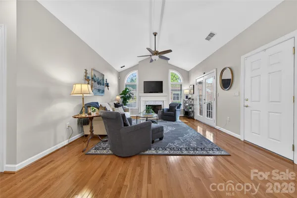 a living room with fireplace furniture and a wooden floor