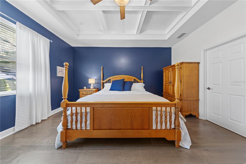 16948 Deer Island Road Tavares, FL 32778 - Photo 17 of 67 a bedroom with a bed and window